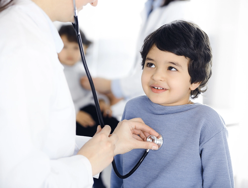 Doctor-woman examining a child patient by stethoscope